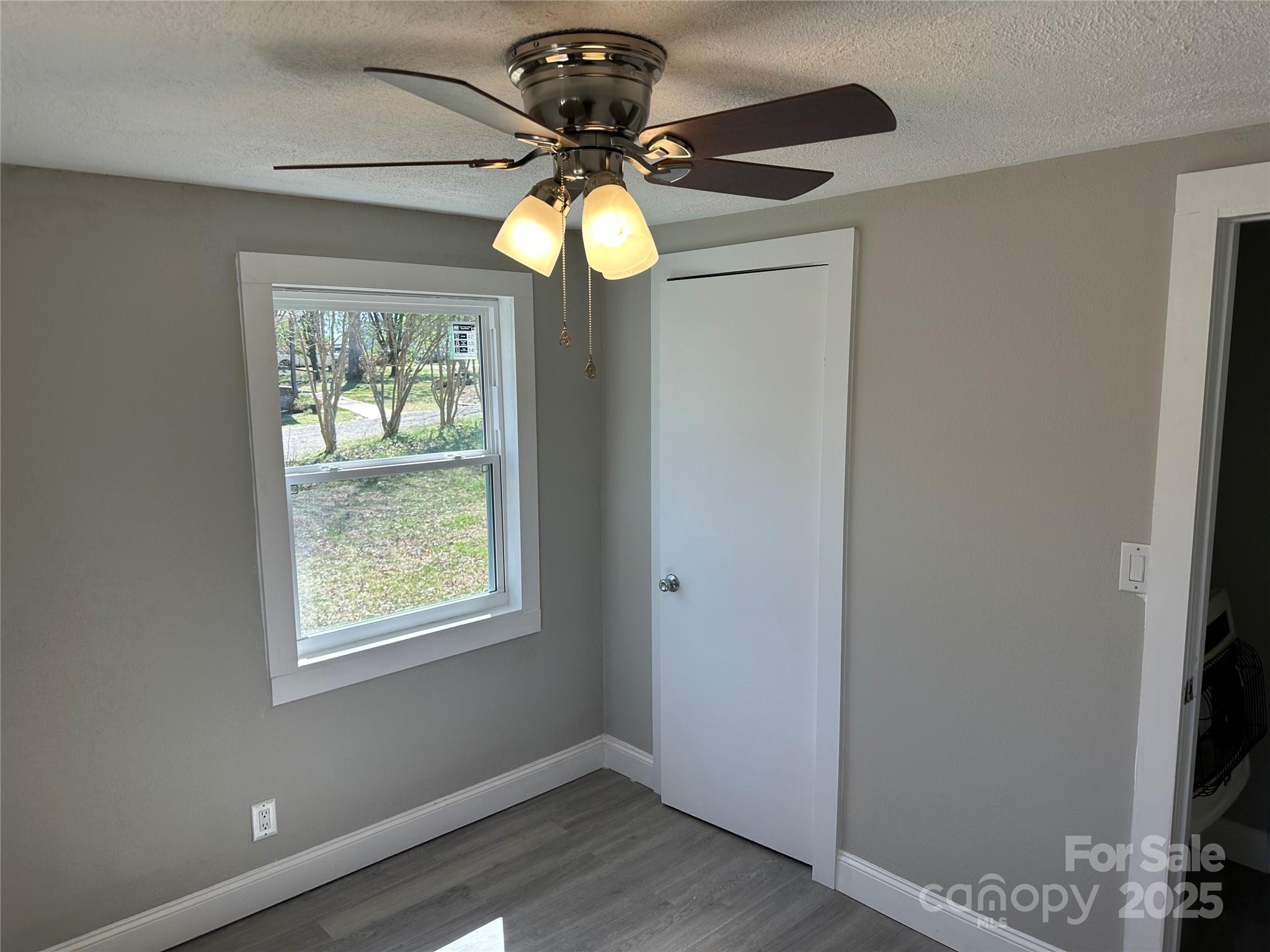 209 Brookview Road Statesville, NC 28625 - Photo 8 of 14 a view of a room with a window and chandelier fan