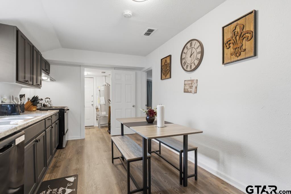 10124 County Road 280 Tyler, TX 75702 - Photo 15 of 47 a view of a kitchen with a table and a stove top oven
