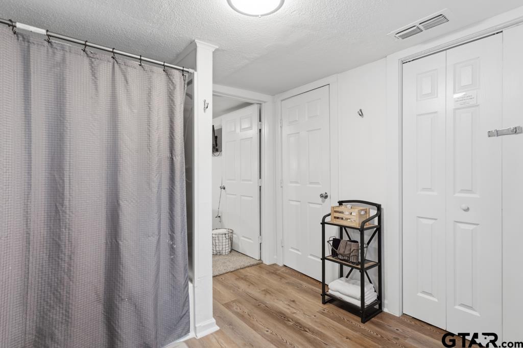 10124 County Road 280 Tyler, TX 75702 - Photo 21 of 47 a view of a closet area with wooden floor