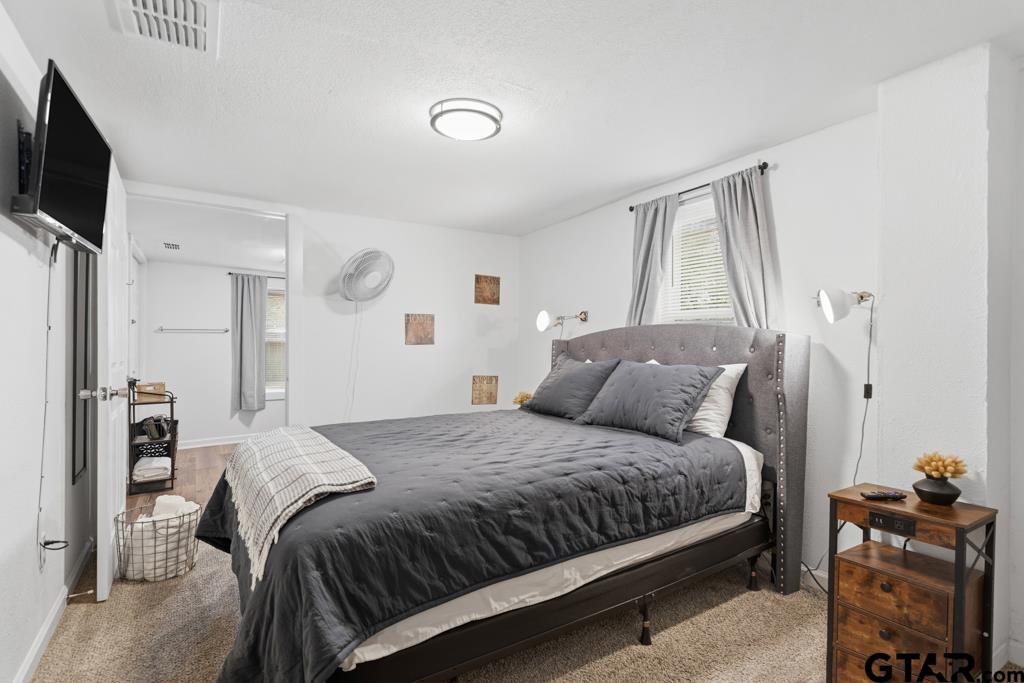 10124 County Road 280 Tyler, TX 75702 - Photo 24 of 47 a bedroom with a bed and flat screen tv