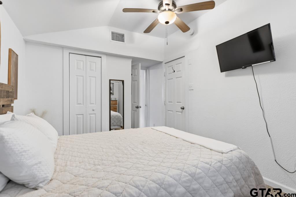 10124 County Road 280 Tyler, TX 75702 - Photo 25 of 47 a bedroom with a bed and a flat screen tv
