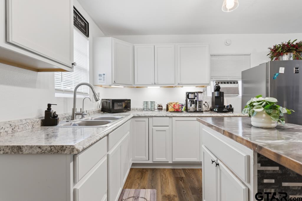 10124 County Road 280 Tyler, TX 75702 - Photo 32 of 47 a kitchen with granite countertop a sink stainless steel appliances and cabinets