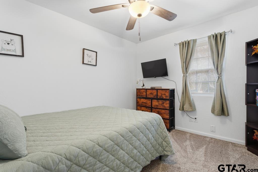 10124 County Road 280 Tyler, TX 75702 - Photo 40 of 47 a bedroom with a bed and a flat screen tv
