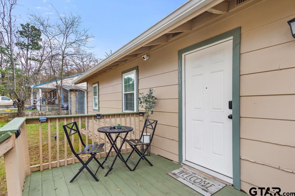 10124 County Road 280 Tyler, TX 75702 - Photo 4 of 47 a view of a patio with table and chairs and wooden floor