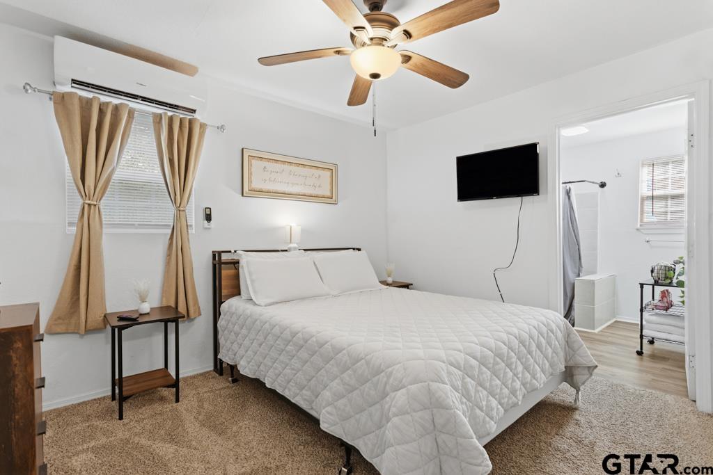 10124 County Road 280 Tyler, TX 75702 - Photo 45 of 47 a bedroom with a large bed a flat tv screen and dresser