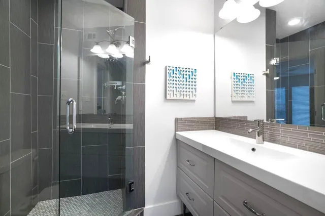 a bathroom with a sink double vanity and a mirror