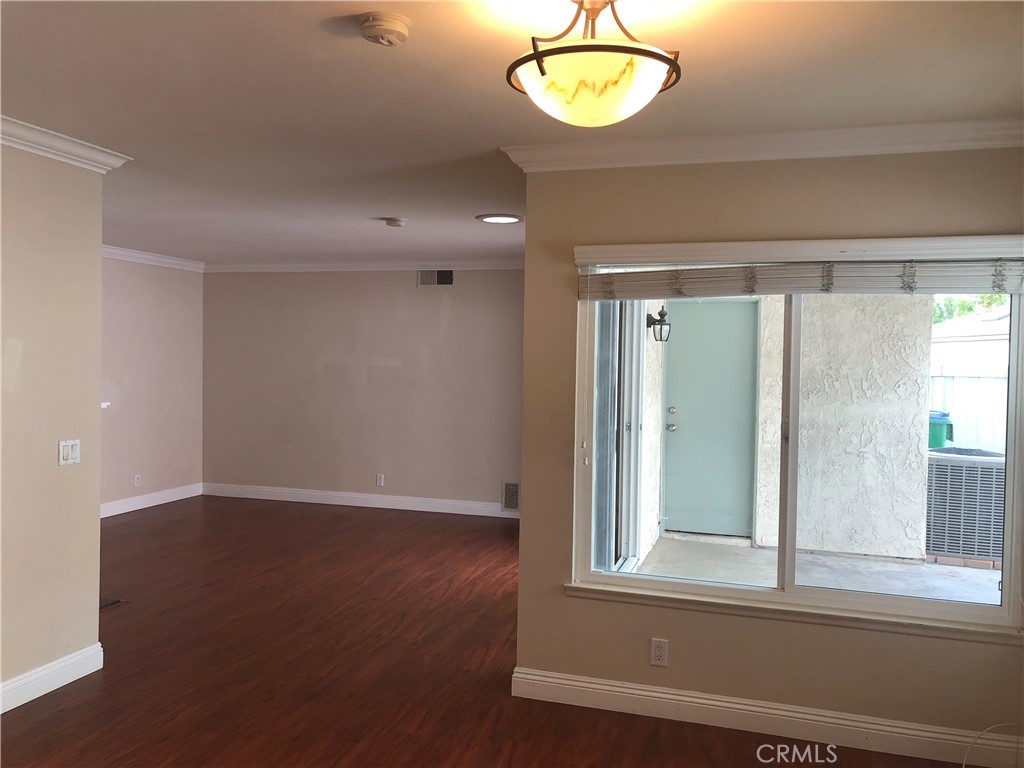 65 Orchard Irvine, CA 92618 - Photo 5 of 21 an empty room with wooden floor and windows