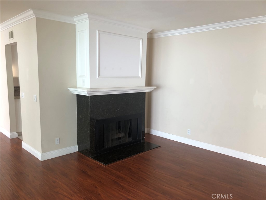 65 Orchard Irvine, CA 92618 - Photo 8 of 21 a room with a fireplace and a wooden floor
