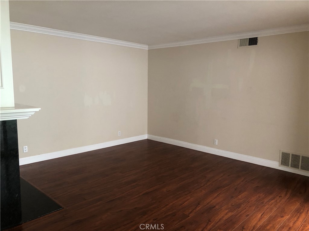 65 Orchard Irvine, CA 92618 - Photo 9 of 21 a view of an empty room with wooden floor and a window
