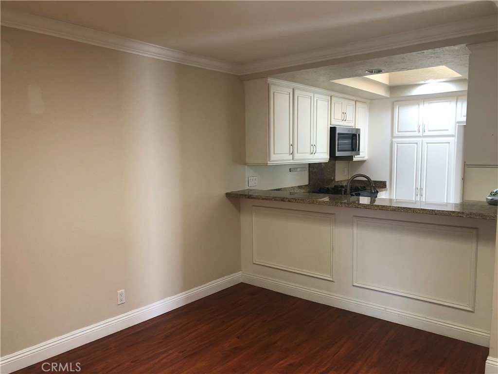 65 Orchard Irvine, CA 92618 - Photo 10 of 21 a view of kitchen with granite countertop white cabinets and window