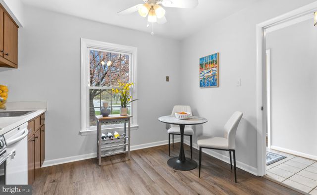 a dining room with furniture window and wooden floor