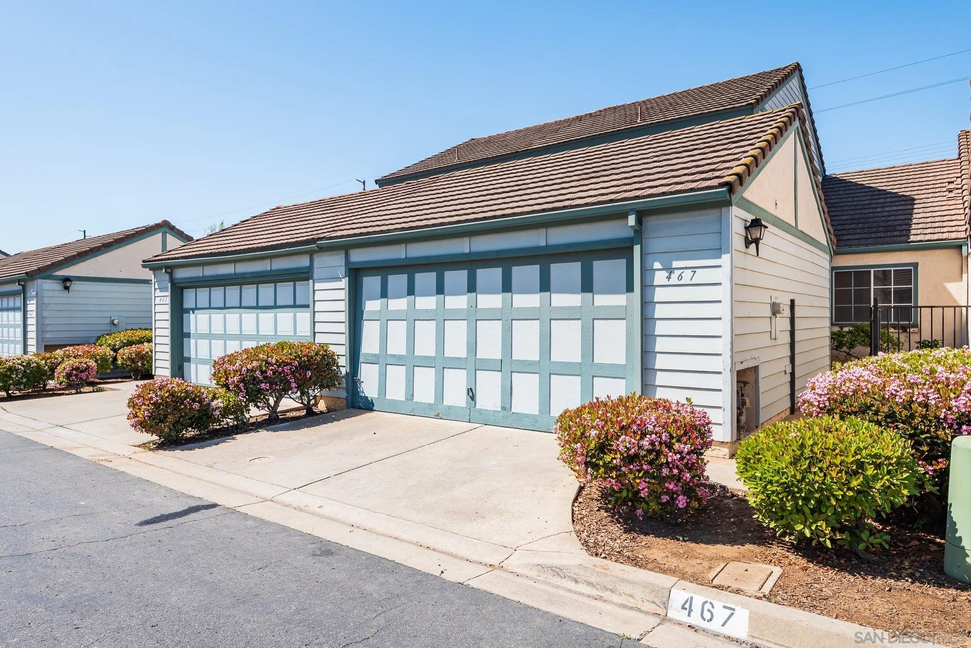 a view of a house with a small yard and a garden