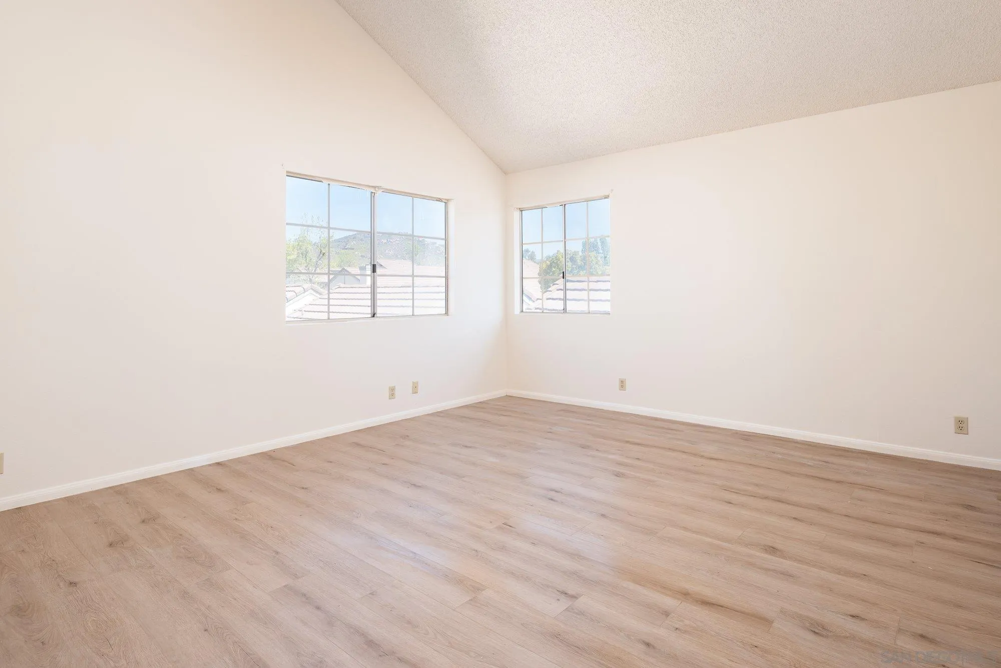 467 Nantucket Glen Escondido, CA 92027 - Photo 13 of 26 an empty room with wooden floor and windows