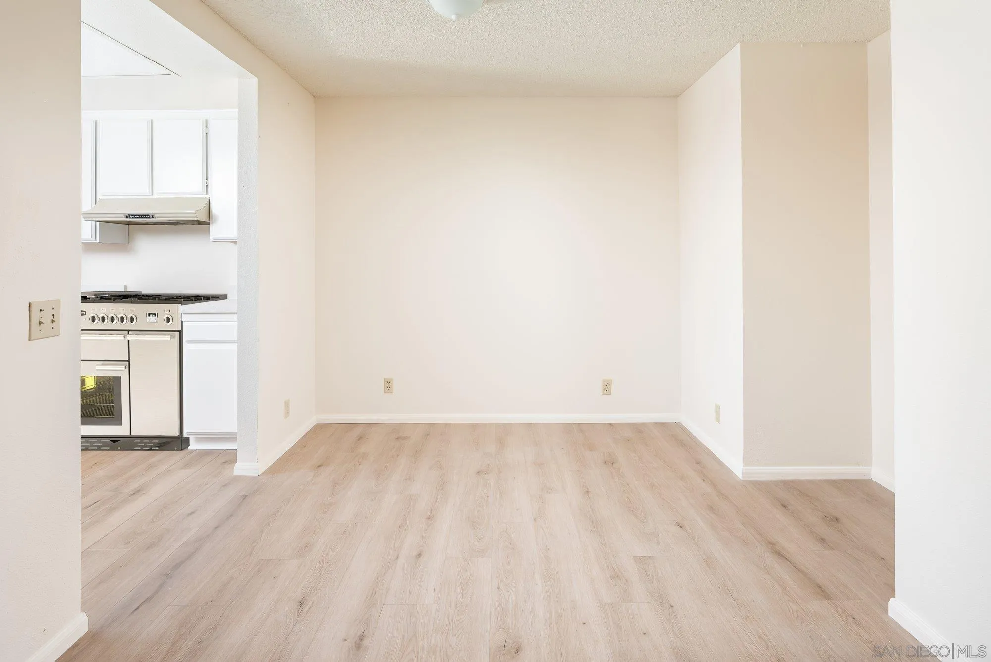 467 Nantucket Glen Escondido, CA 92027 - Photo 7 of 26 a view of empty room with wooden floor and kitchen
