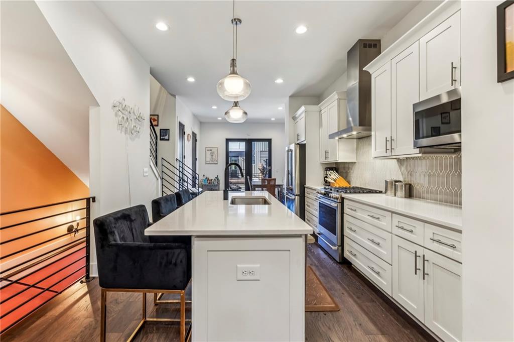 2336 Mason Drive Atlanta, GA 30316 - Photo 3 of 19 a kitchen with stainless steel appliances kitchen island granite countertop a sink and cabinets