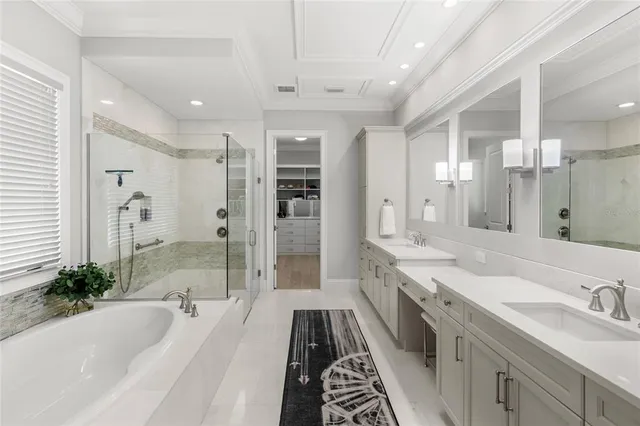 a spacious bathroom with a tub sink shower and mirror