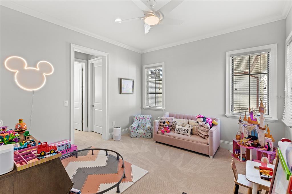 10224 Mattraw Place Orlando, FL 32836 - Photo 26 of 44 a bedroom with furniture toys and a chandelier