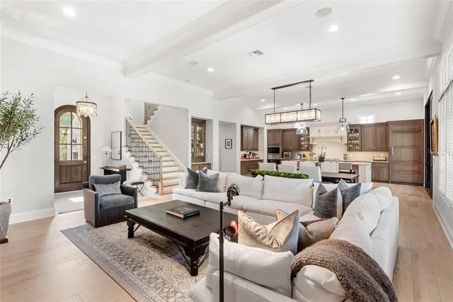 a living room with furniture dining table and a refrigerator