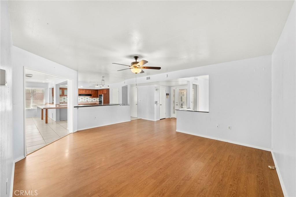25915 Roanoke Road Menifee, CA 92586 - Photo 11 of 58 a view of a livingroom with wooden floor and a ceiling fan