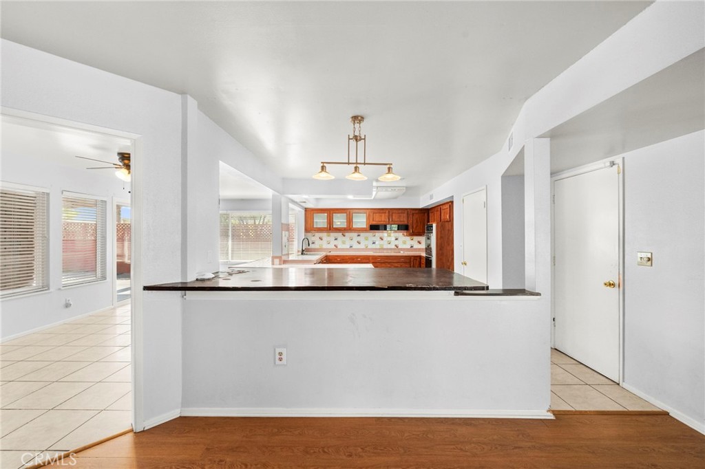 25915 Roanoke Road Menifee, CA 92586 - Photo 13 of 58 a view of a kitchen with stainless steel appliances wooden floor and large window