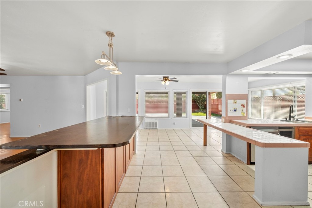25915 Roanoke Road Menifee, CA 92586 - Photo 14 of 58 a kitchen with a sink a counter top space and appliances
