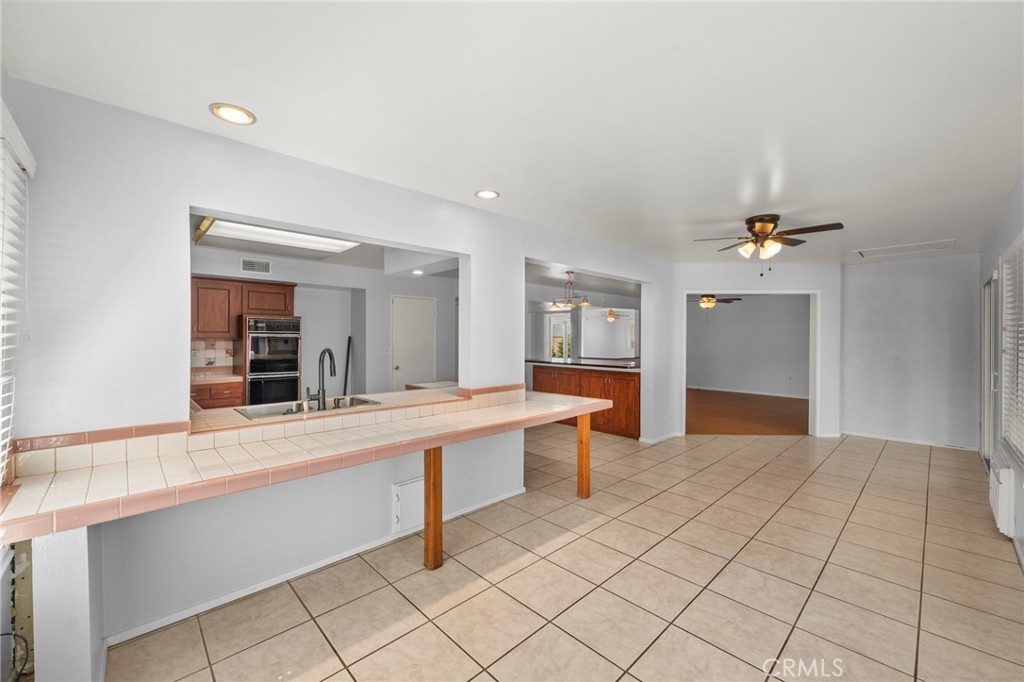 25915 Roanoke Road Menifee, CA 92586 - Photo 19 of 58 a view of a kitchen with kitchen island granite countertop a refrigerator and a sink
