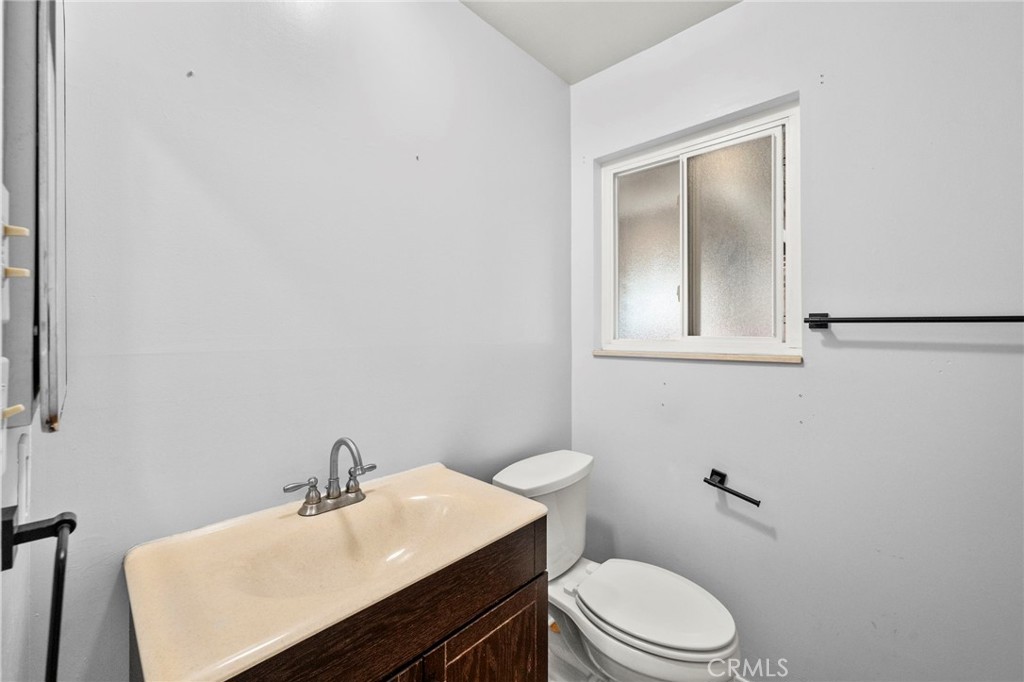 25915 Roanoke Road Menifee, CA 92586 - Photo 24 of 58 a bathroom with a sink a toilet and mirror