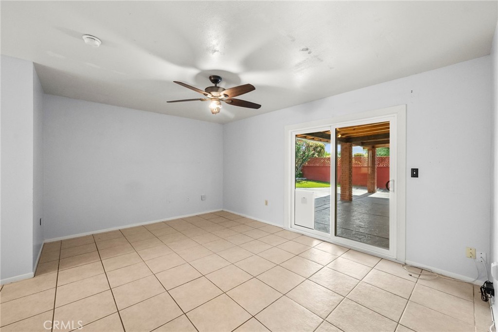 25915 Roanoke Road Menifee, CA 92586 - Photo 26 of 58 an empty room with chandelier fan and windows