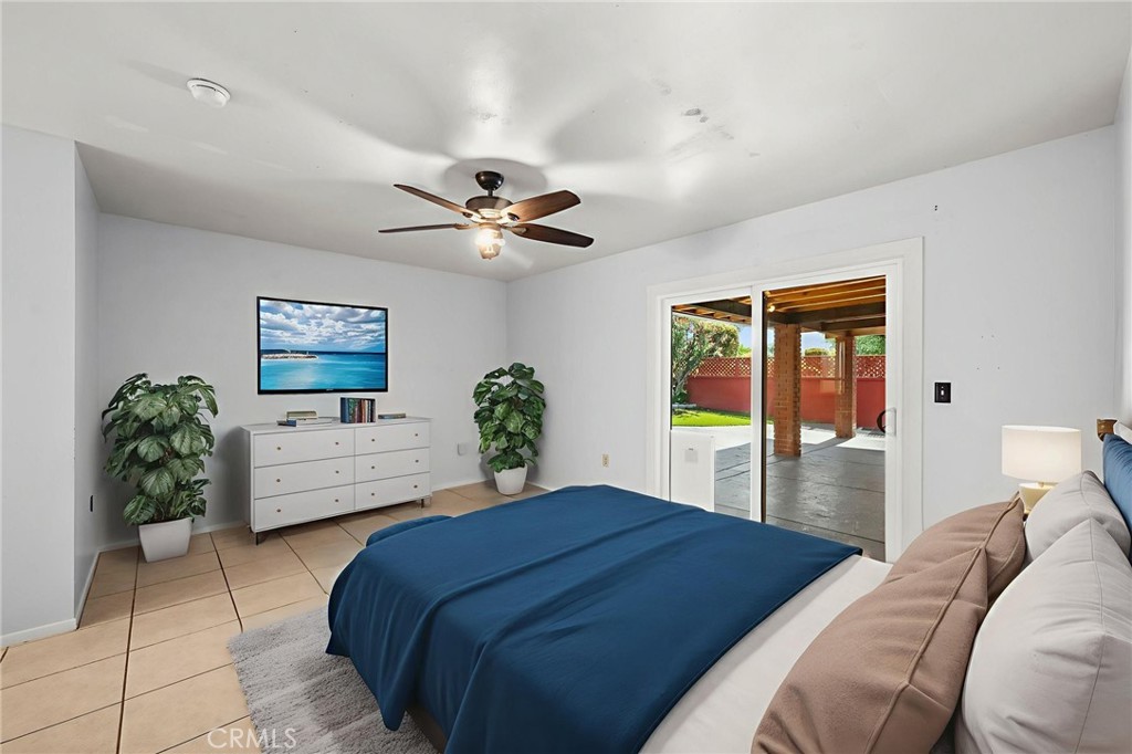 25915 Roanoke Road Menifee, CA 92586 - Photo 27 of 58 a bedroom with a large bed and a chandelier