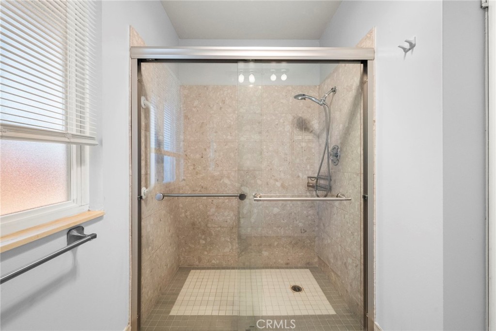 25915 Roanoke Road Menifee, CA 92586 - Photo 32 of 58 a bathroom with a glass shower door