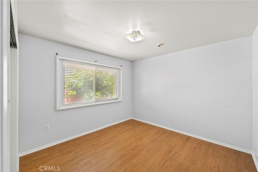 25915 Roanoke Road Menifee, CA 92586 - Photo 33 of 58 a view of an empty room with wooden floor and a window
