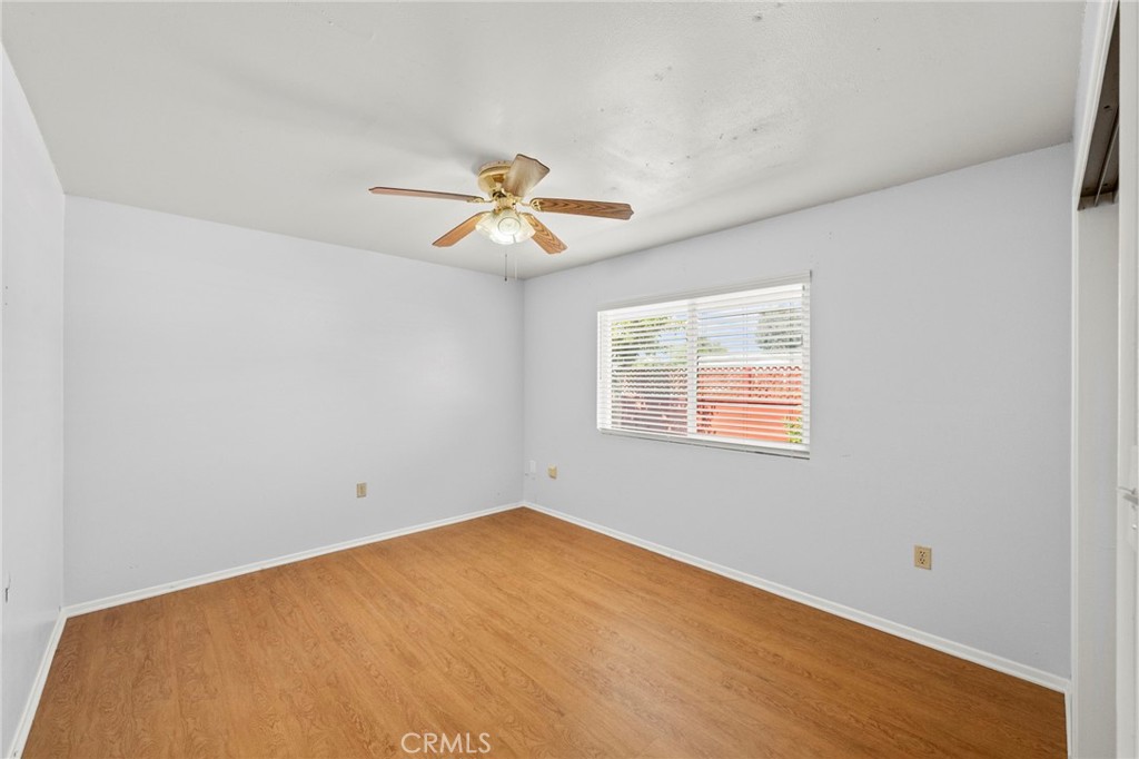 25915 Roanoke Road Menifee, CA 92586 - Photo 36 of 58 an empty room with a window and a ceiling fan