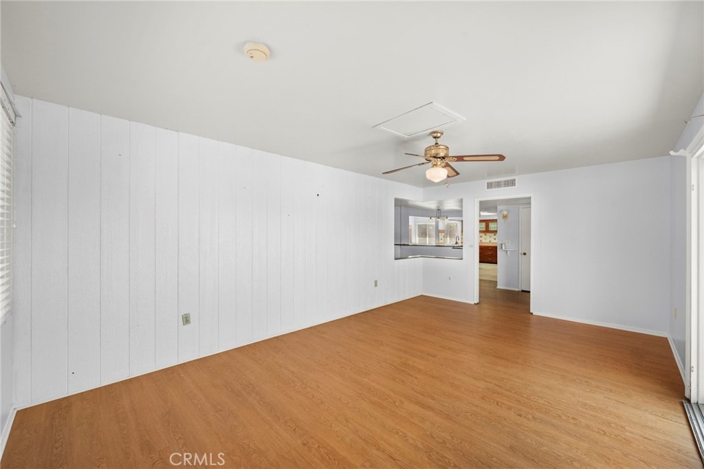 25915 Roanoke Road Menifee, CA 92586 - Photo 4 of 58 a view of a kitchen with wooden floor and a ceiling fan
