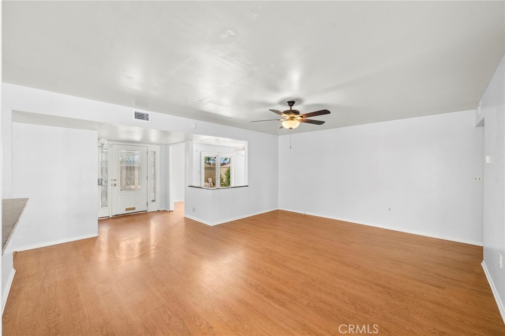 25915 Roanoke Road Menifee, CA 92586 - Photo 9 of 58 a view of empty room with wooden floor and ceiling fan