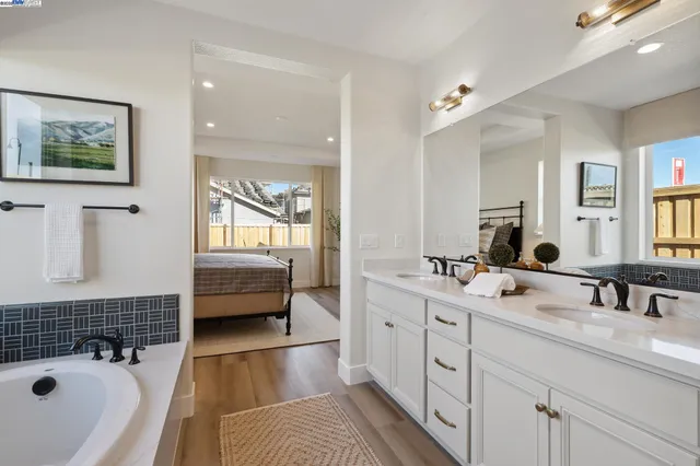 a bathroom with a tub a window and walk in closet