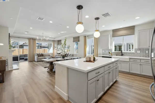 a kitchen with counter space dining table and chairs
