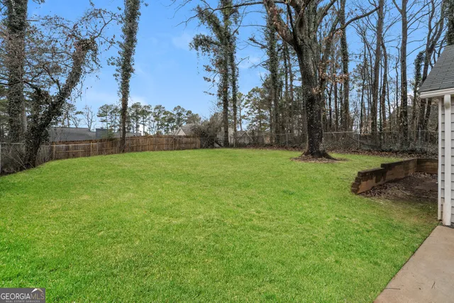 a view of a backyard with large trees