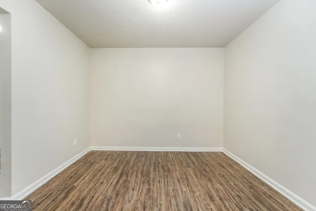 a view of a room with wooden floor