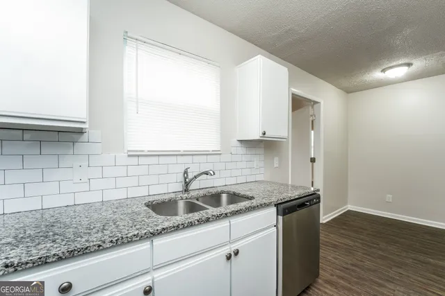 a kitchen with a sink and cabinets
