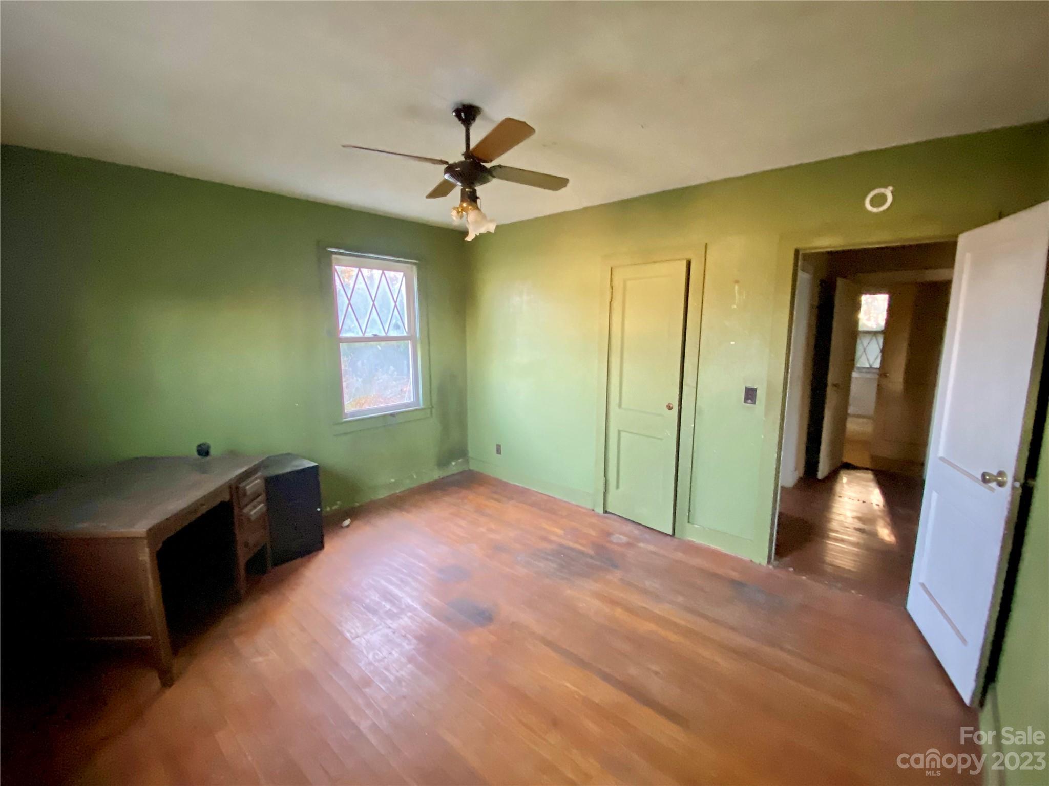 793 Silver Creek Road Mill Spring, NC 28756 - Photo 17 of 20 a view of empty room with window and ceiling fan