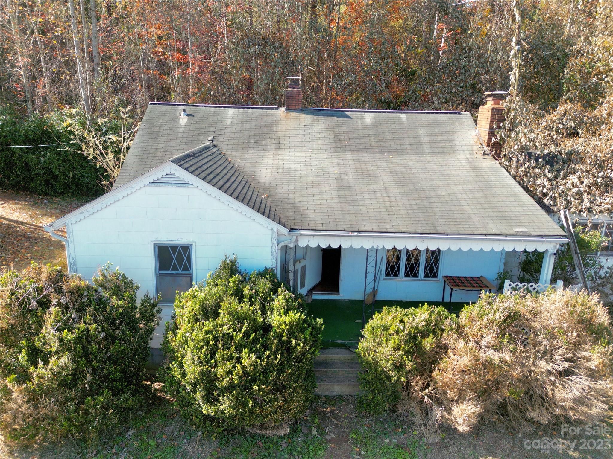 793 Silver Creek Road Mill Spring, NC 28756 - Photo 2 of 20 a view of a house with a yard and potted plants