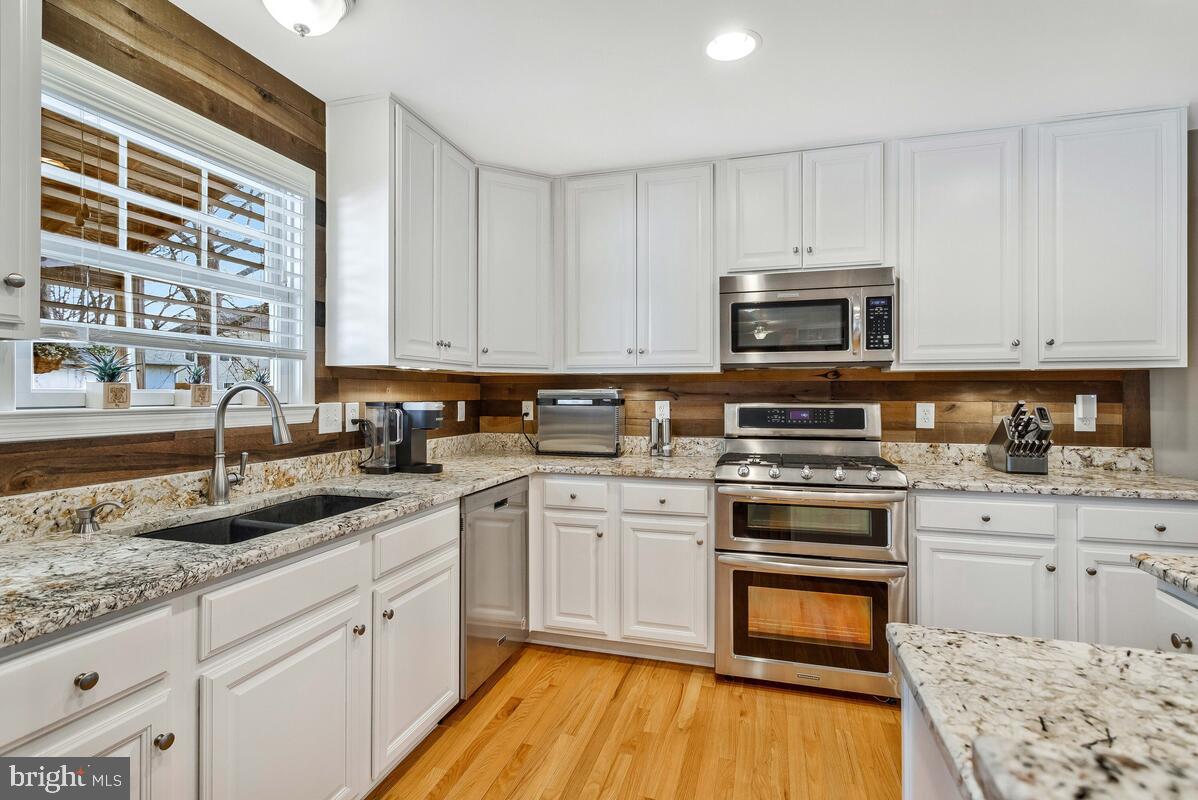 1713 Shore Drive Edgewater, MD 21037 - Photo 11 of 44 a kitchen with stainless steel appliances granite countertop a stove a sink and a microwave