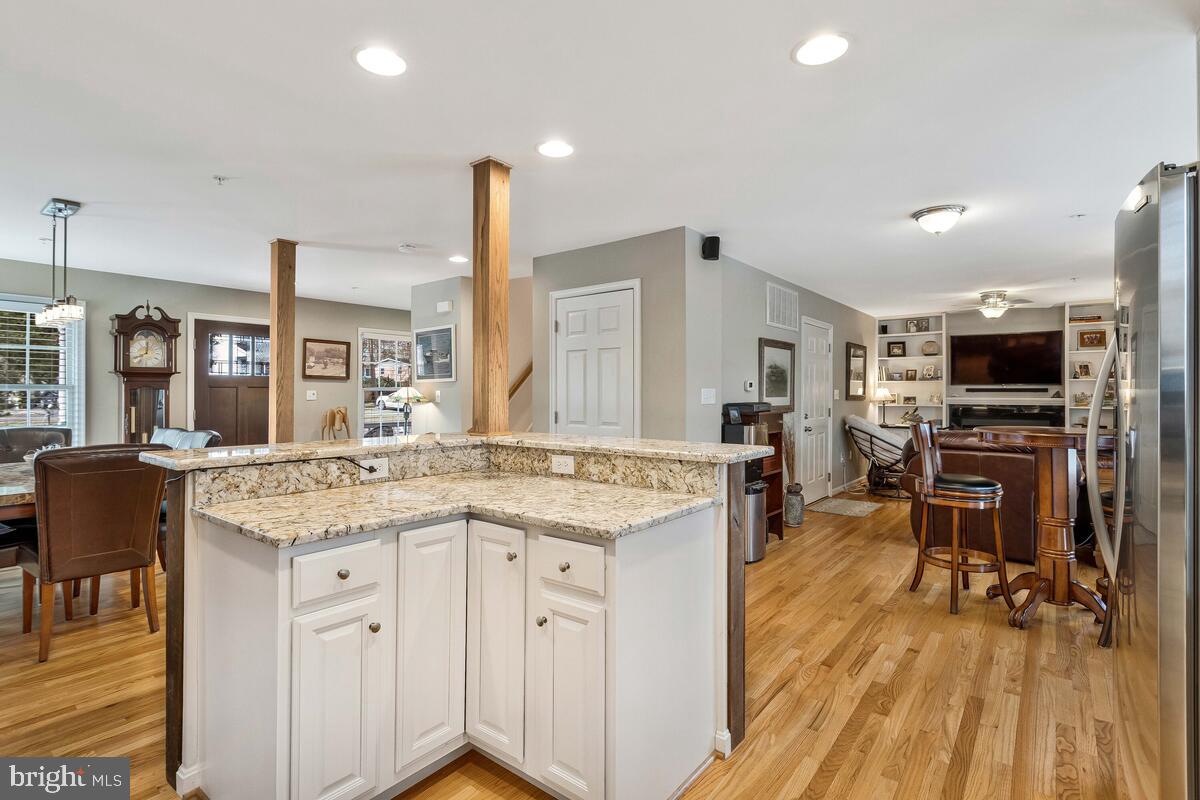 1713 Shore Drive Edgewater, MD 21037 - Photo 12 of 44 a kitchen with stainless steel appliances granite countertop a table chairs stove and cabinets