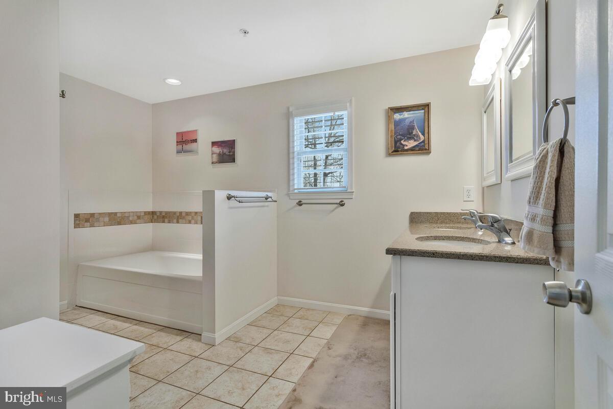 1713 Shore Drive Edgewater, MD 21037 - Photo 21 of 44 a bathroom with a sink a toilet and tub