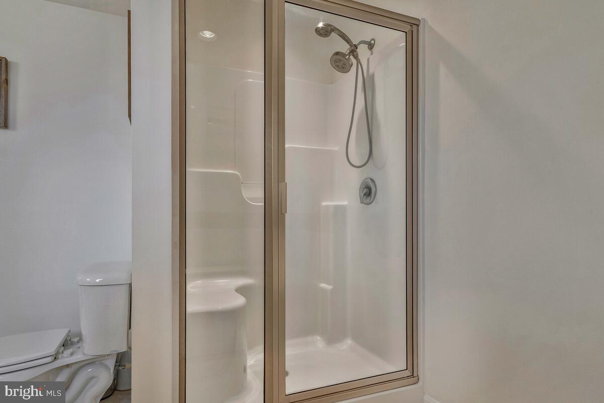 1713 Shore Drive Edgewater, MD 21037 - Photo 23 of 44 a bathroom with a glass shower door