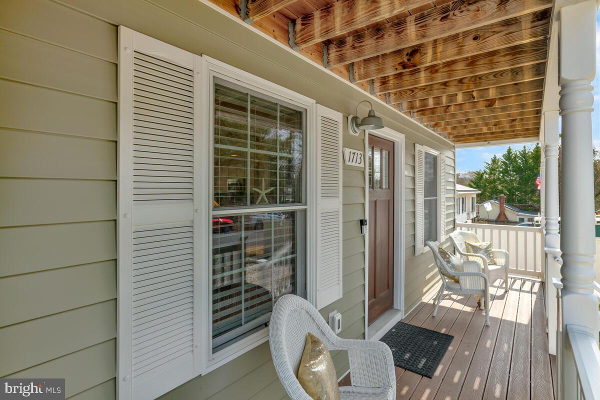 1713 Shore Drive Edgewater, MD 21037 - Photo 3 of 44 a balcony with chairs and wooden floor