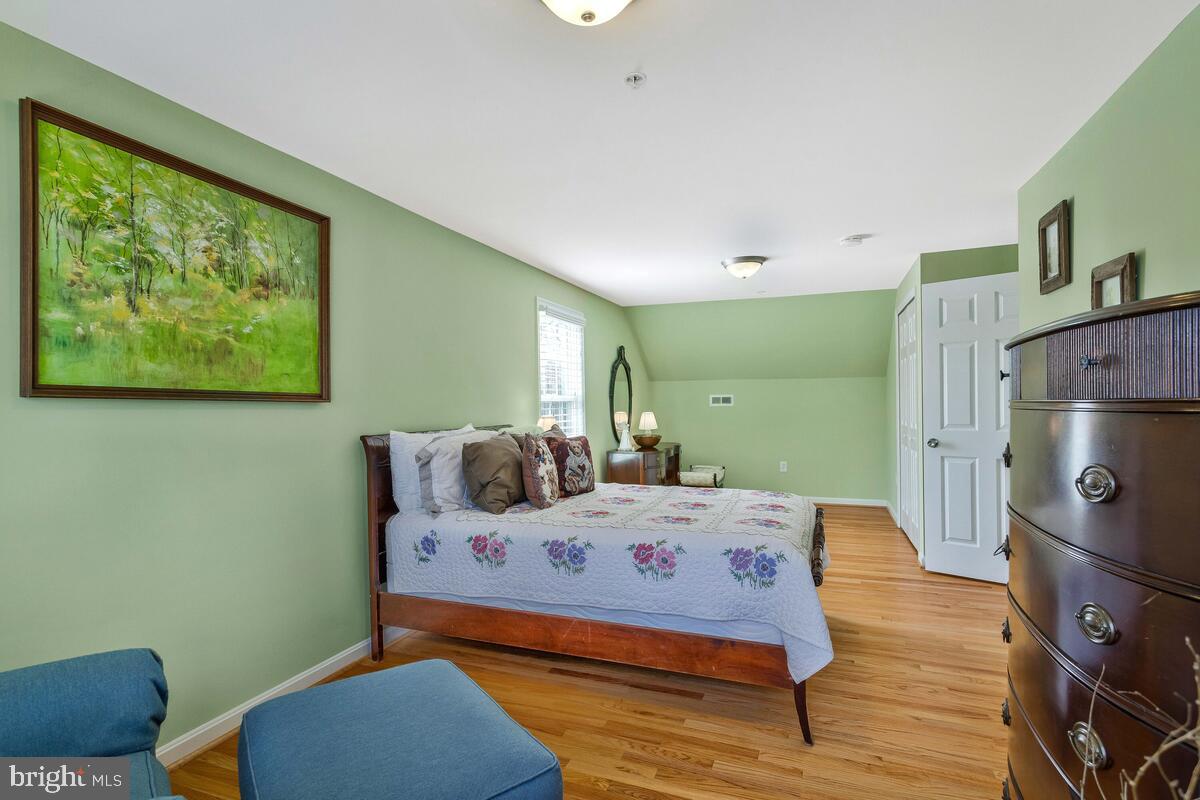 1713 Shore Drive Edgewater, MD 21037 - Photo 32 of 44 a bedroom with a bed and wooden floor