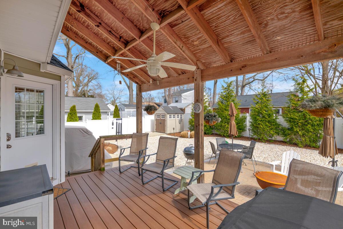 1713 Shore Drive Edgewater, MD 21037 - Photo 36 of 44 a view of a patio with table and chairs and wooden floor