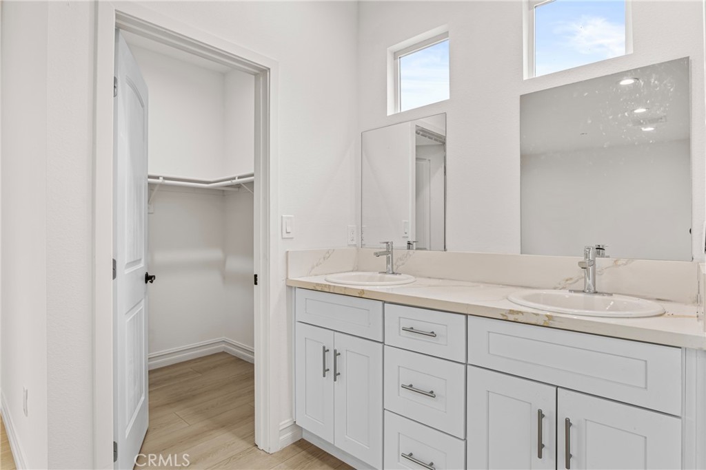 230 East Hoffer Street Banning, CA 92220 - Photo 14 of 32 a bathroom with a double vanity sink and a mirror