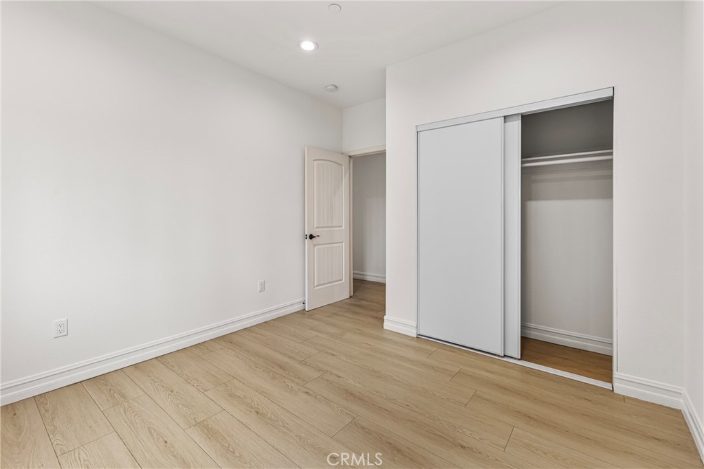 230 East Hoffer Street Banning, CA 92220 - Photo 15 of 32 a view of an empty room with wooden floor and closet